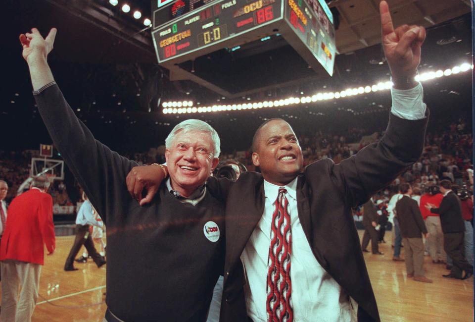 OCU president Jerald Walker and head coach Win Case celebrate an NAIA Division I men's basketball title after the game in 1996.