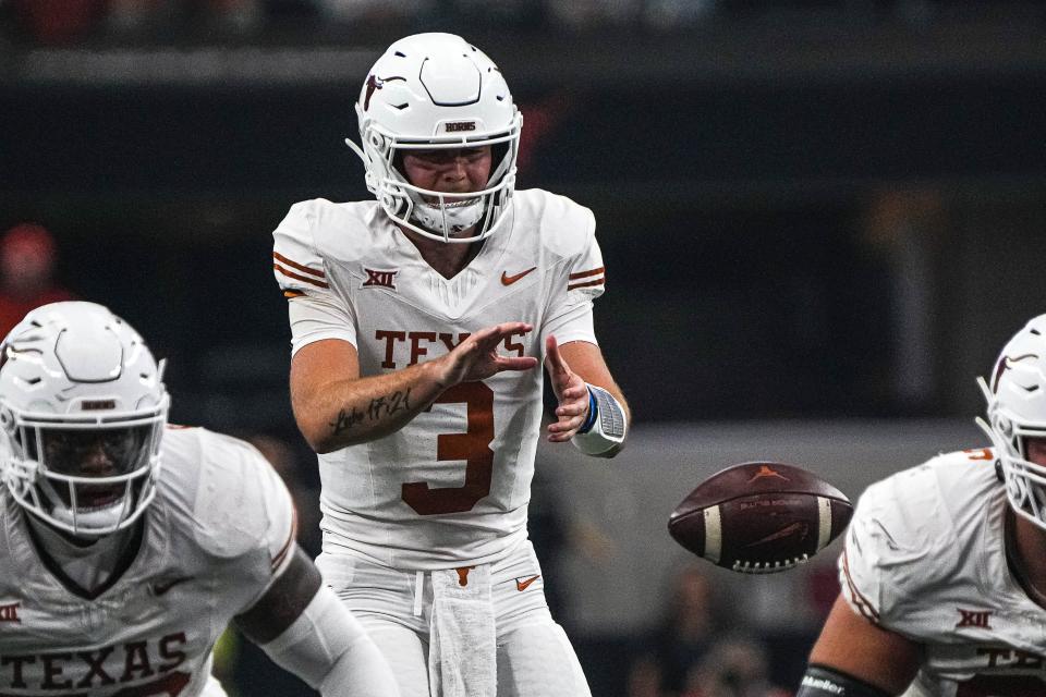 Texas Longhorns quarterback Quinn Ewers (3) snaps the ball during the Big 12 Championship game against the Oklahoma State Cowboys at AT&T stadium on Saturday, Dec. 2, 2023 in Arlington. At halftime of the Big 12 championship game against Oklahoma State, Texas quarterback Quinn Ewers and the Longhorns' offense are on pace to break several records for the Big 12 title game.