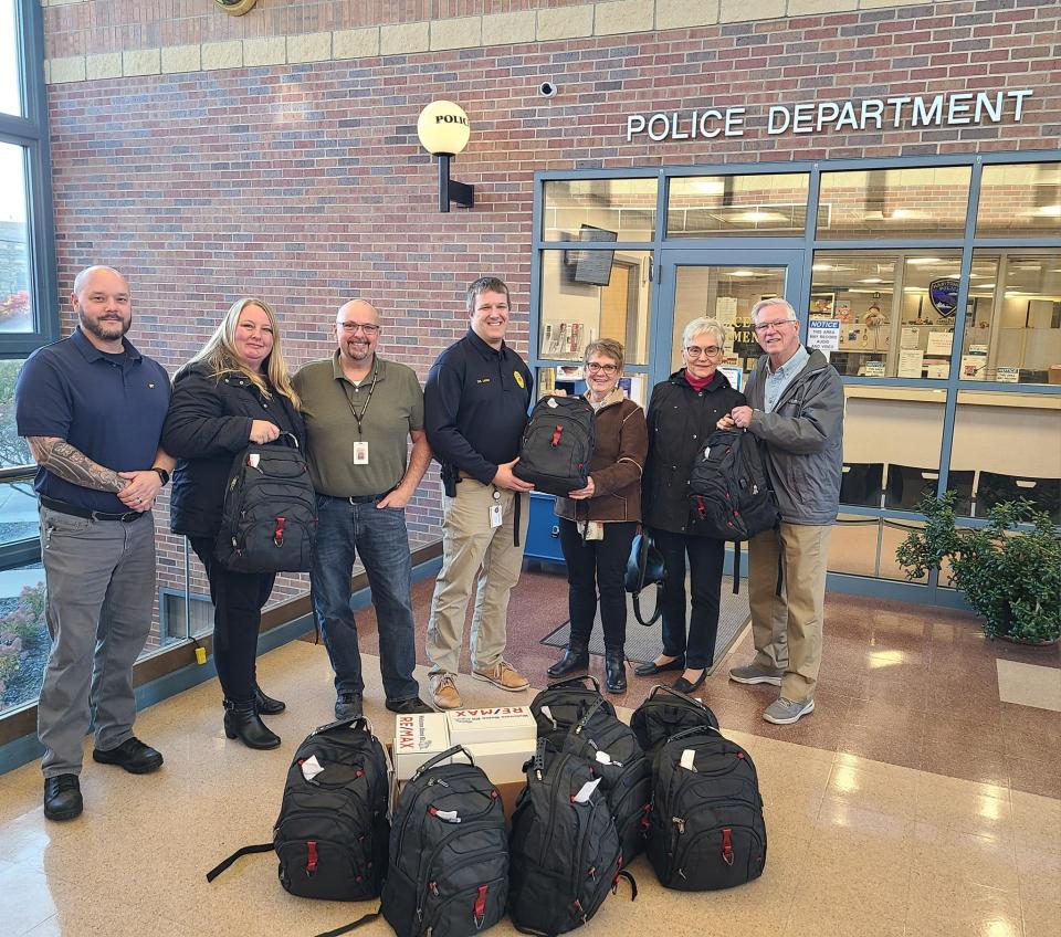 Sunrise Rotary members delivery hygiene kits to detectives David McCue and Jerod Lecher and officer Eric Schultz.