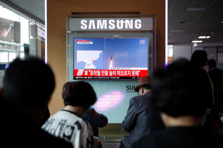 People watch a TV broadcasting a news report on North Korea's failed missile launch from its east coast, at a railway station in Seoul, South Korea, April 16, 2017. REUTERS/Kim Hong-Ji