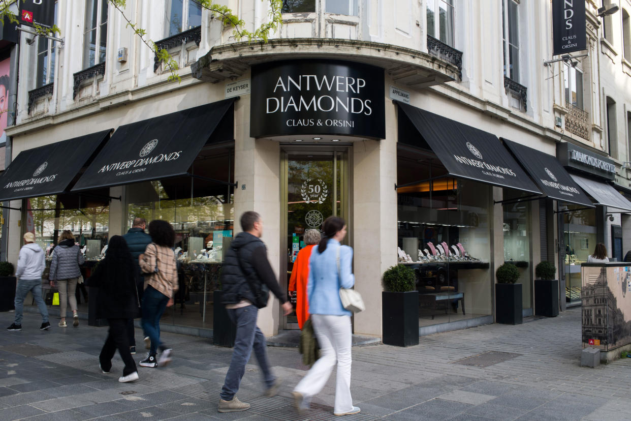 Pedestrians pass window shoppers browsing the Orsini Diamonds store in the Diamond Quarter of Antwerp