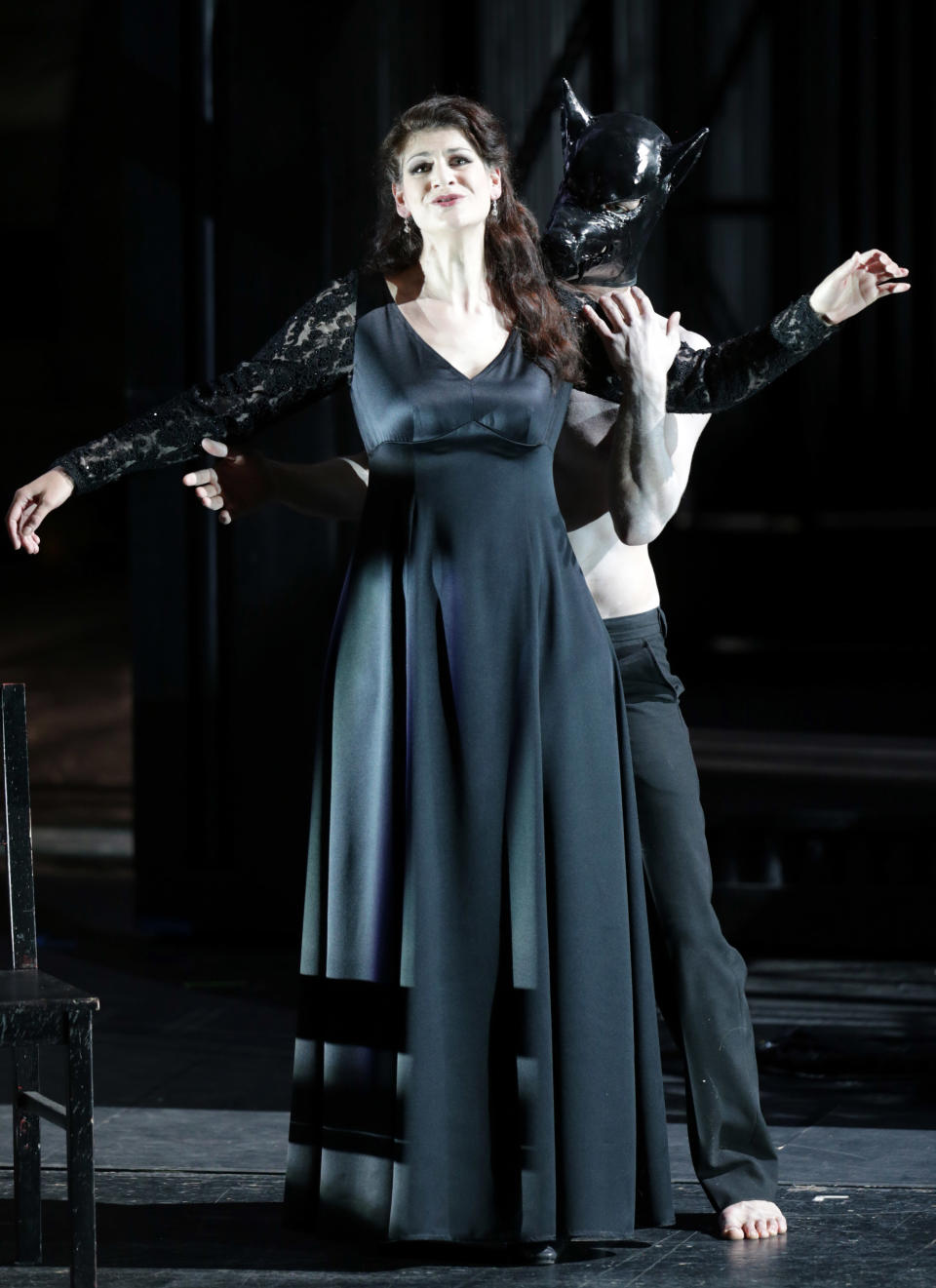 In this picture taken Friday, June 21, 2013, Anja Harteros in the role of Leonora sings during a dress rehearsal for the opera "Il Trovatore" by Giuseppe Verdi in the Bavarian State Opera House in Munich, southern Germany. This wild new production by Olivier Py opened the company's annual Munich Opera Festival. It's a non-stop barrage of nightmarish images mixing styles and periods that assault the audience at lightning speed on a multi-tiered revolving set. (AP Photo/Matthias Schrader)