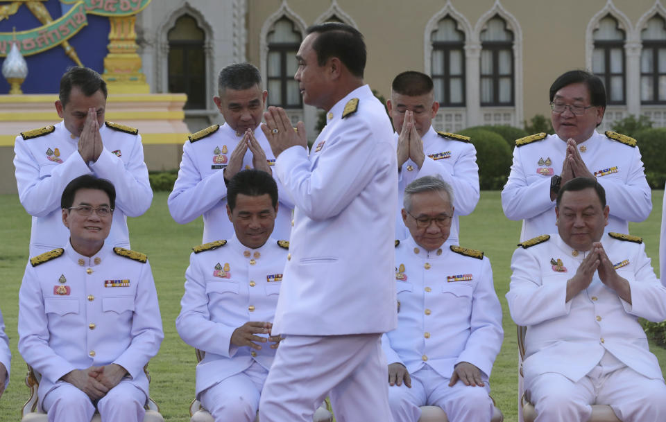 Thailand's Prime Minister Prayuth Chan-ocha arrives for a group photo with his cabinet members at the government house in Bangkok Tuesday, July 16, 2019. Prayuth on Tuesday led his 36 cabinet members to take their oath in front of Thailand's King Maha Vajiralongkorn. (AP Photo/Sakchai Lalit)