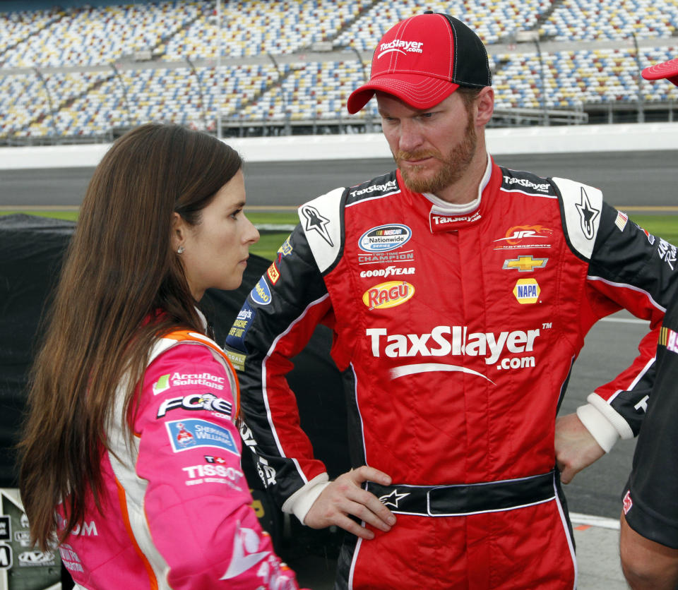 Dale Earnhardt Jr, right, talks with Danica Patrick during qualifying for Saturday's NASCAR Nationwide series auto race at Daytona International Speedway in Daytona Beach, Fla., Friday, Feb. 21, 2014. (AP Photo/David Graham)