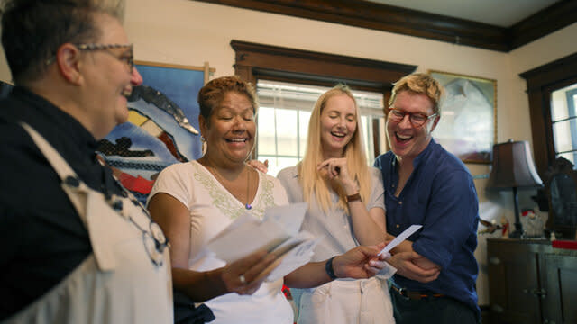 Ella, Katarina, Johan and Sue laughing together in her home.