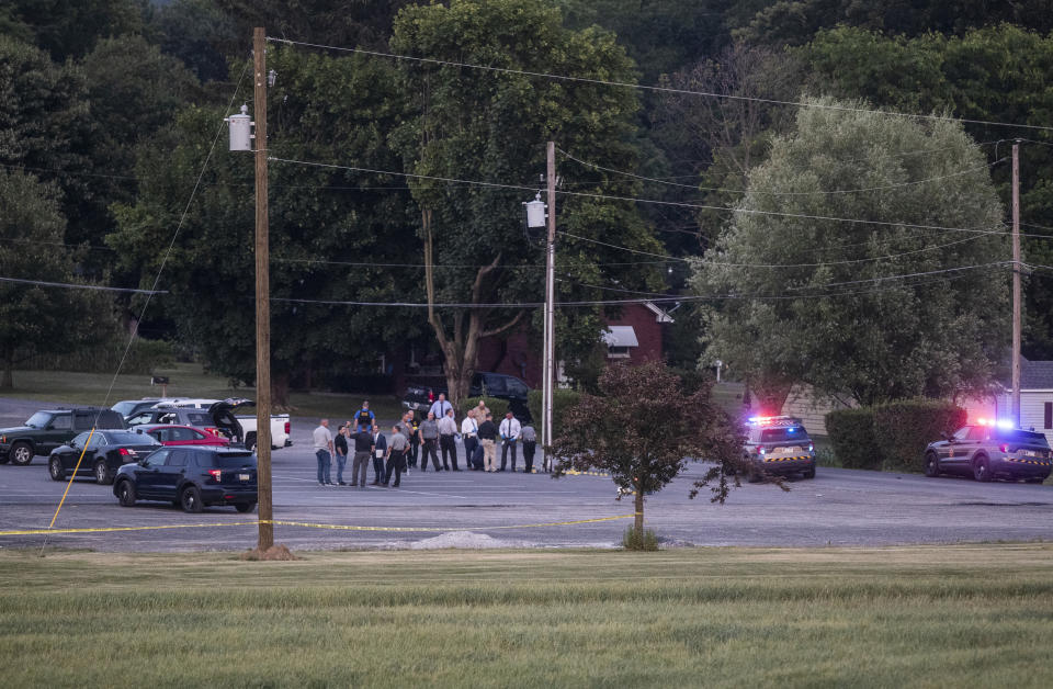 Authorities gather at the scene of a shootout between Pennsylvania State Troopers and a gunman near Mifflintown, Pa. The suspect's pickup truck is seen in center, Saturday, June 17, 2023. (Sean Simmers/The Patriot-News via AP)