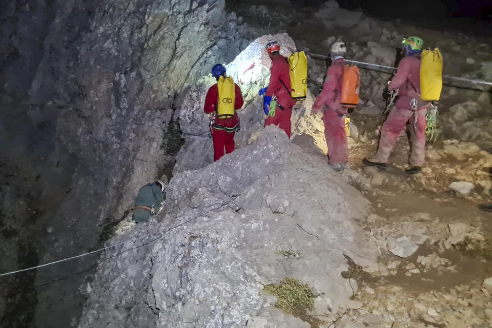 Members of the CNSAS, Italian alpine and speleological rescuers, start to descent on ropes the Morca cave during a rescue operation near Anamur, south Turkey, Monday, Sept. 11, 2023. A rescue operation is underway in Turkey’s Taurus Mountains to bring out an American researcher who fell seriously ill at a depth of some 1,000 meters (3,000 feet) from the entrance of one of world’s deepest caves last week and was unable to climb out himself. Mark Dickey is being assisted by international rescuers who by Monday had brought him up to 300 meters (nearly 1,000 feet). (CNSAS Via AP)