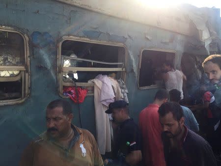 Egyptians search for survivors at the site of a crash where two trains collided near the Khorshid station in Egypt's coastal city of Alexandria, Egypt August 11, 2017. REUTERS/Osama Nageb