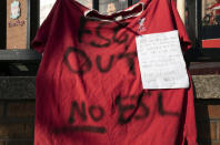 A football shirt is seen outside Liverpool's Anfield Stadium protesting the formation of the European Super League, Liverpool, England, Monday, April 19, 2021. Players at the 12 clubs setting up their own Super League could be banned from this year's European Championship and next year's World Cup, UEFA President Aleksander Ceferin said Monday. (AP Photo/Jon Super)