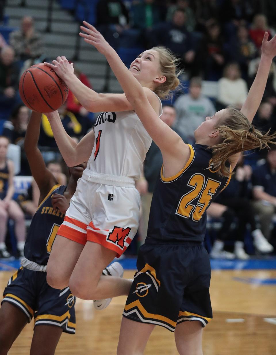 Marlington's Maria Warner cuts through the defense of Streetsboro's Maria Embry ,left, and Maddy Hajec in the first half at Lake High Wednesday, Feb. 23, 2022.