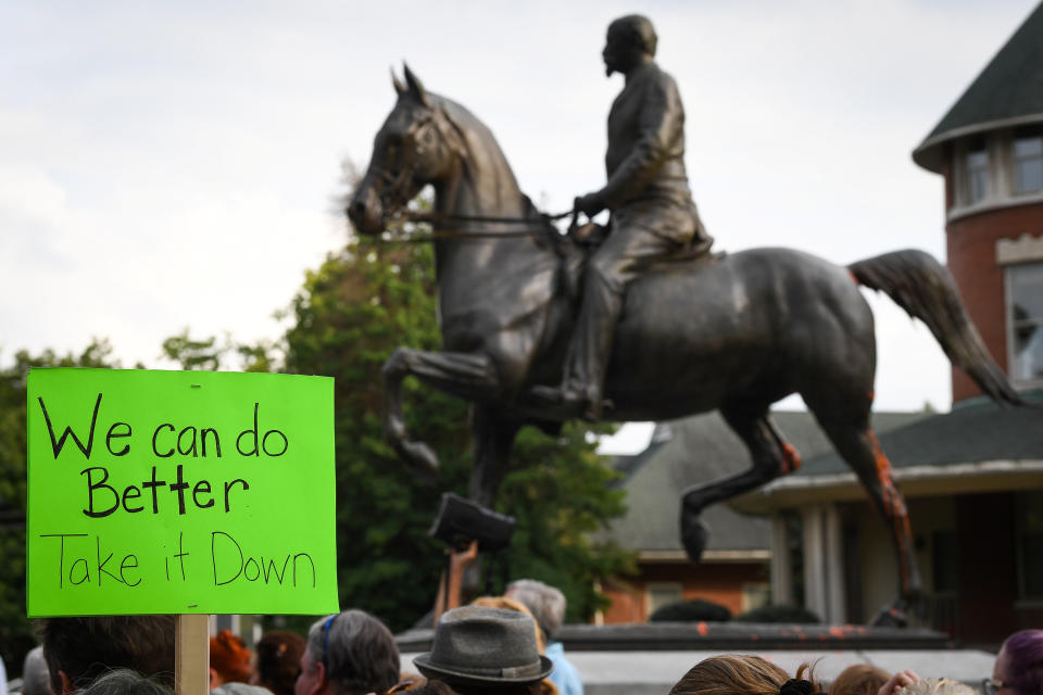 Protesters gather below a monument dedicated to Confederate Maj. John B. Castleman while demanding that it be removed from the public square in Louisville, Kentucky, on Aug. 14, 2017. (Photo: Bryan Woolston/Reuters)