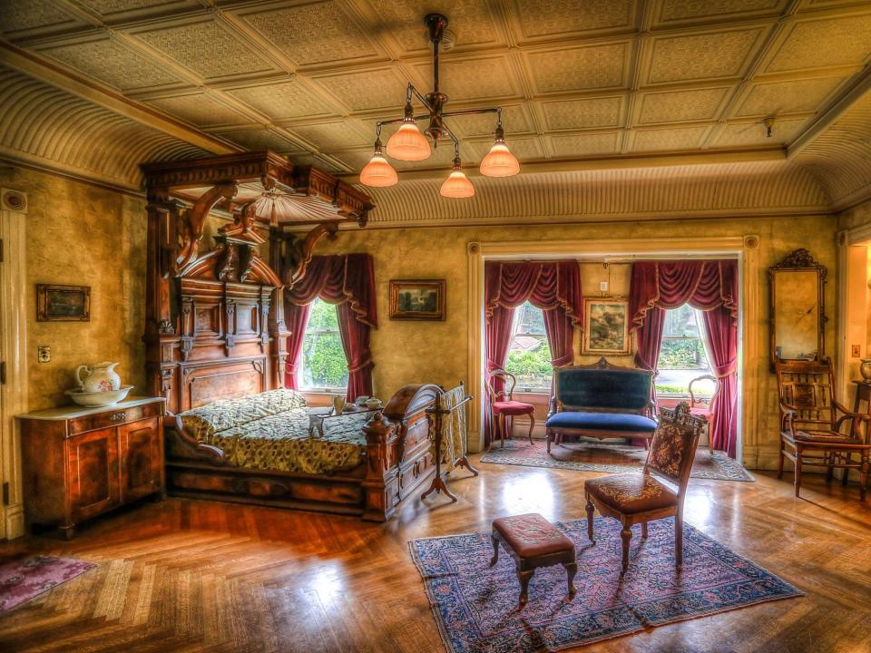 the master bedroom at the winchester mansion with a bed and seating area