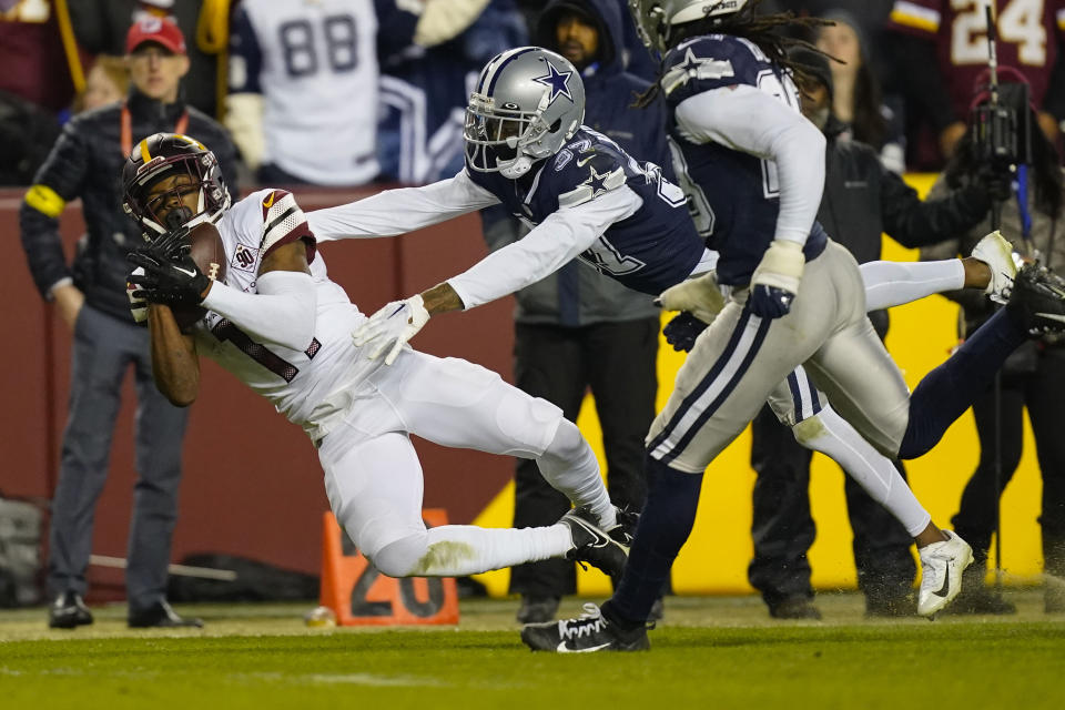 Washington Commanders wide receiver Terry McLaurin (17) makes a catch for a first down against Dallas Cowboys cornerback Trayvon Mullen (37) during the second half an NFL football game, Sunday, Jan. 8, 2023, in Landover, Md. (AP Photo/Patrick Semansky)