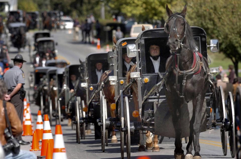 The first of several Amish funerals proceeds down Georgetown Road in Georgetown, Pennsylvania, to bury one of five young girls killed earlier this week in a school shooting at West Nickel Mines Amish School, Thursday, October 5, 2006.