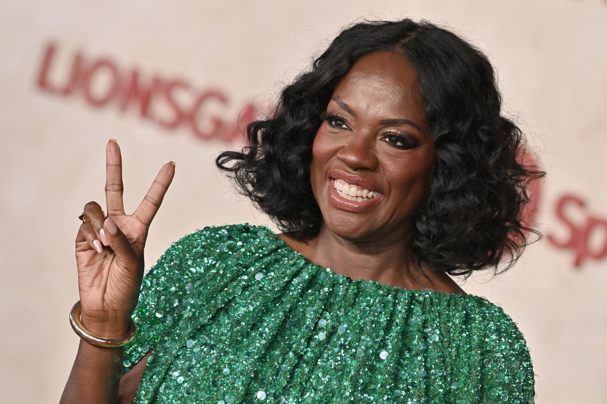 Viola Davis throws up a peace sign wearing a sequined green dress at "The Hunger Games: The Ballad Of Songbirds & Snakes" Los Angeles Premiere at TCL Chinese Theatre on November 13, 2023 in Hollywood, California.