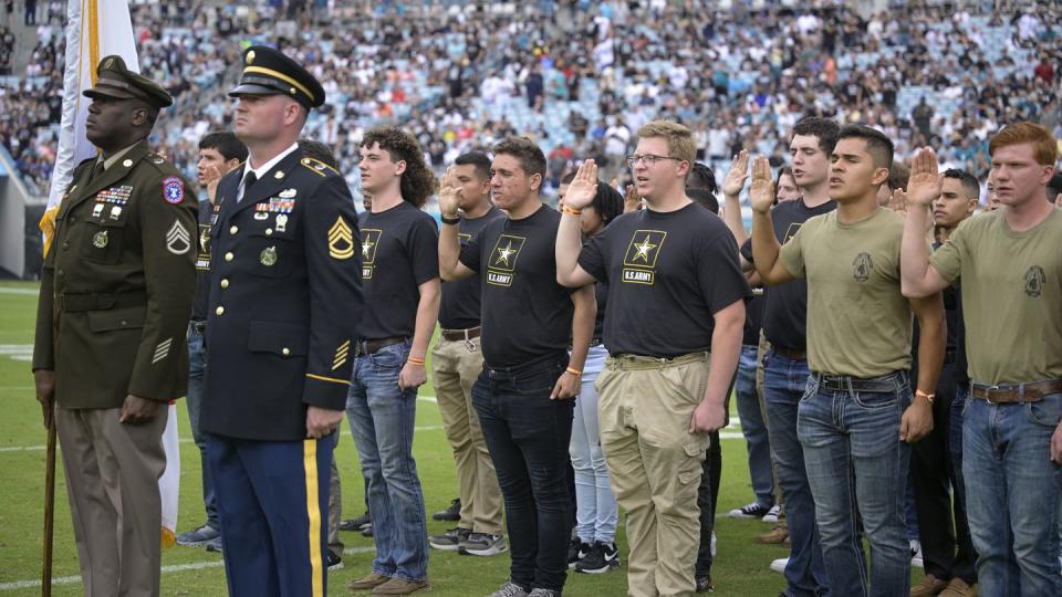 Army recruits are sworn in during halftime on Salute to Service military appreciation day at an NFL football game between the Jacksonville Jaguars and the Las Vegas Raiders, Sunday, Nov. 6, 2022, in Jacksonville, Fla. (Phelan M. Ebenhack/AP)