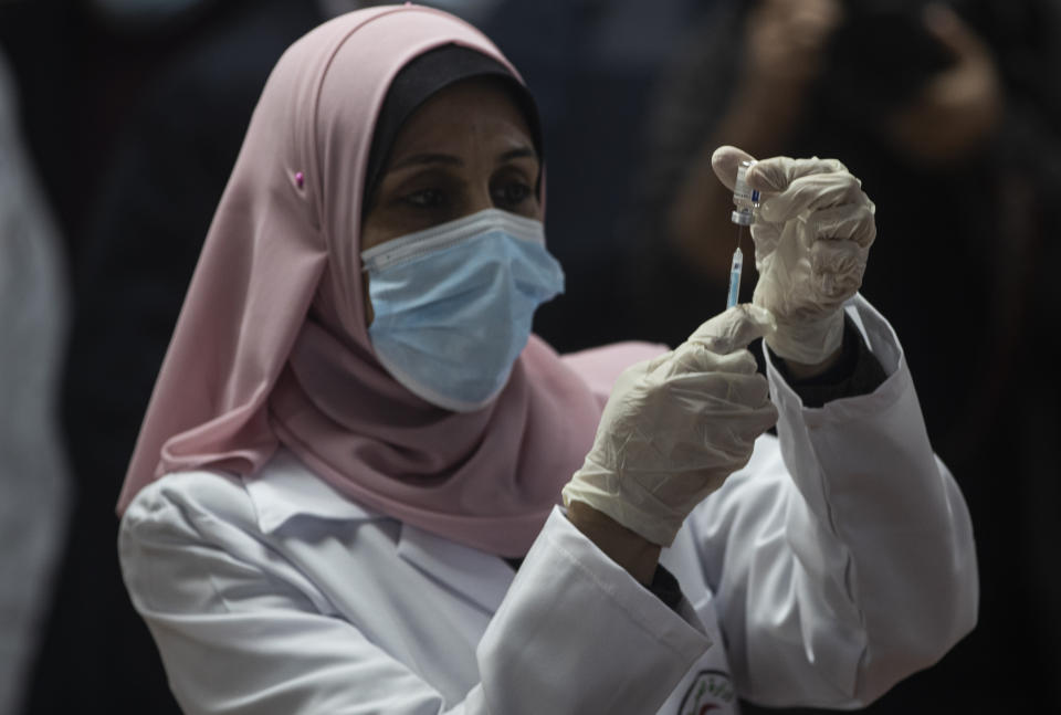 A Palestinian medic prepares a shot of the Russian-made Sputnik V coronavirus vaccine, in Gaza City, Monday, Feb. 22, 2021. (AP Photo/Khalil Hamra)