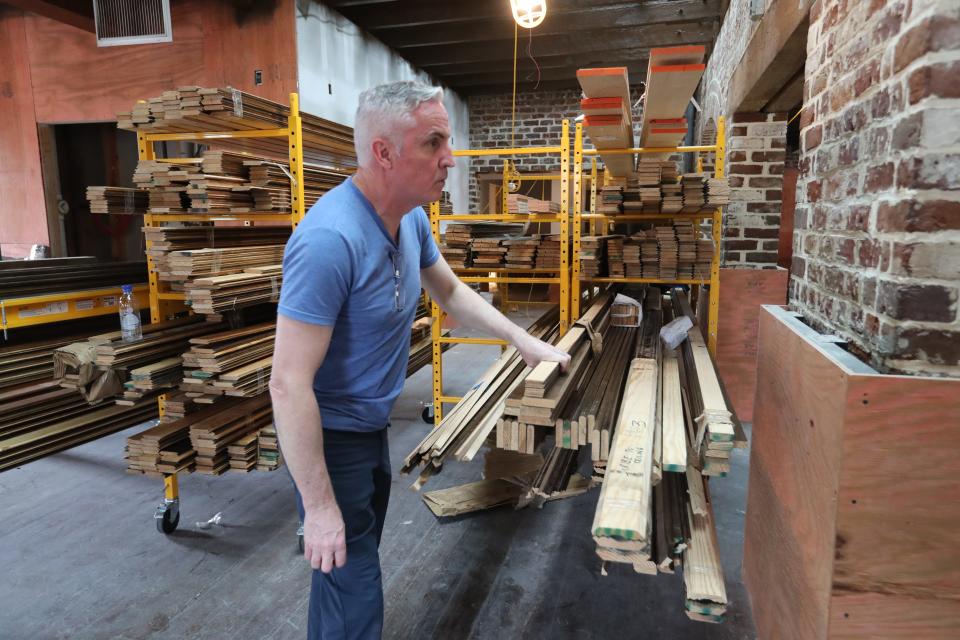 Darren Fagan looks through the many pieces of wood that were shipped over from Ireland to be assembled at the Wexford Irish Pub in City Market.