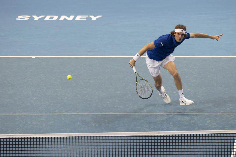 Stefenos Tsitsipas plays a shot in his doubles match with Michail Pervolarakis of Greece against Poland's Hubert Hurkacz and Jan Zielinski of Poland during their match at the ATP Cup tennis tournament in Sydney, Saturday, Jan. 1, 2022. (AP Photo/Steve Christo)