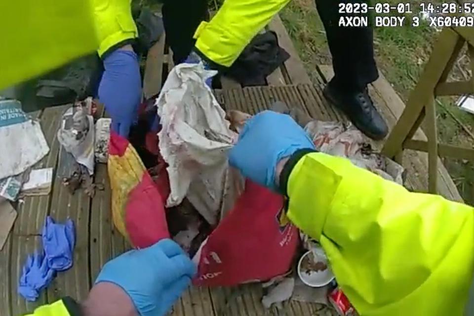 The moment police discovered the remains of Marten and Gordon’s baby covered in leaves in a rubbish-filled shopping bag (Metropolitan Police)