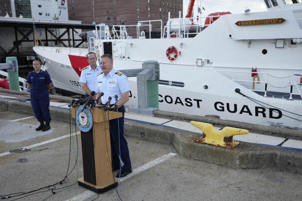 Capt. Jason Neubauer, chief investigator, U.S. Coast, right, speaks with the media as U.S. Coast Guard Rear Adm. John Mauger, commander of the First Coast Guard District, center, looks on during a news conference, Sunday, June 25, 2023, at Coast Guard Base Boston, in Boston. The U.S. Coast Guard said it is leading an investigation into the loss of the Titan submersible that was carrying five people to the Titanic, to determine what caused it to implode. (AP Photo/Steven Senne)