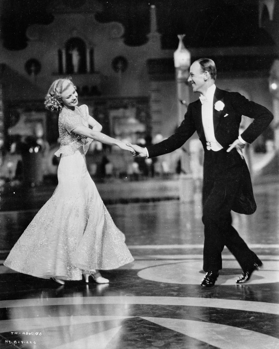 1935:  Ginger Rogers (Virginia McMath) (1911 - 1995) and Fred Astaire (Frederick Austerlitz) (1899 - 1987) as Dale Tremont and Jerry Travers respectively, dancing together in the RKO film,'Top Hat'. Director Mark Sandrich. Costumes by Bernard Newman.  (Photo via John Kobal Foundation/Getty Images)