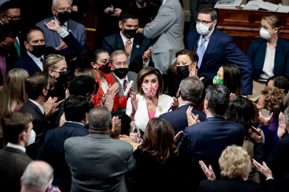 House Speaker Nancy Pelosi and House Democrats cheer after passage of the Build Back Better Act on Nov. 19, 2021, in Washington.