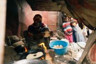 <p>Boys look as a woman displaced from the Red Sea port city of Hodeidah makes bread at a shelter in Sanaa, Yemen July 18, 2018. (Photo: Khaled Abdullah/Reuters) </p>