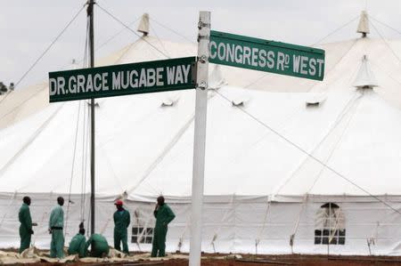 Workers put the final touches at the venue of Zanu PF's congress with a street named after First Lady Grace Mugabe in Harare, December 2, 2014. REUTERS/Philimon Bulawayo
