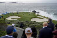 Joseph Bramlett, middle, follows his putt on the 7th green of the Pebble Beach Golf Links during the third round of the AT&T Pebble Beach Pro-Am golf tournament in Pebble Beach, Calif., Saturday, Feb. 4, 2023. (AP Photo/Godofredo A. Vásquez)