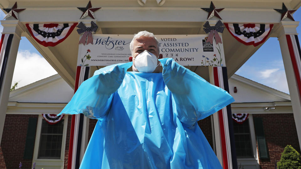 Brendan Williams, president of the New Hampshire Health Care Association, wears an isolation gown with no sleeve openings for hands. The gown was provided by the federal government for use at a senior care center. (Photo: ASSOCIATED PRESS)