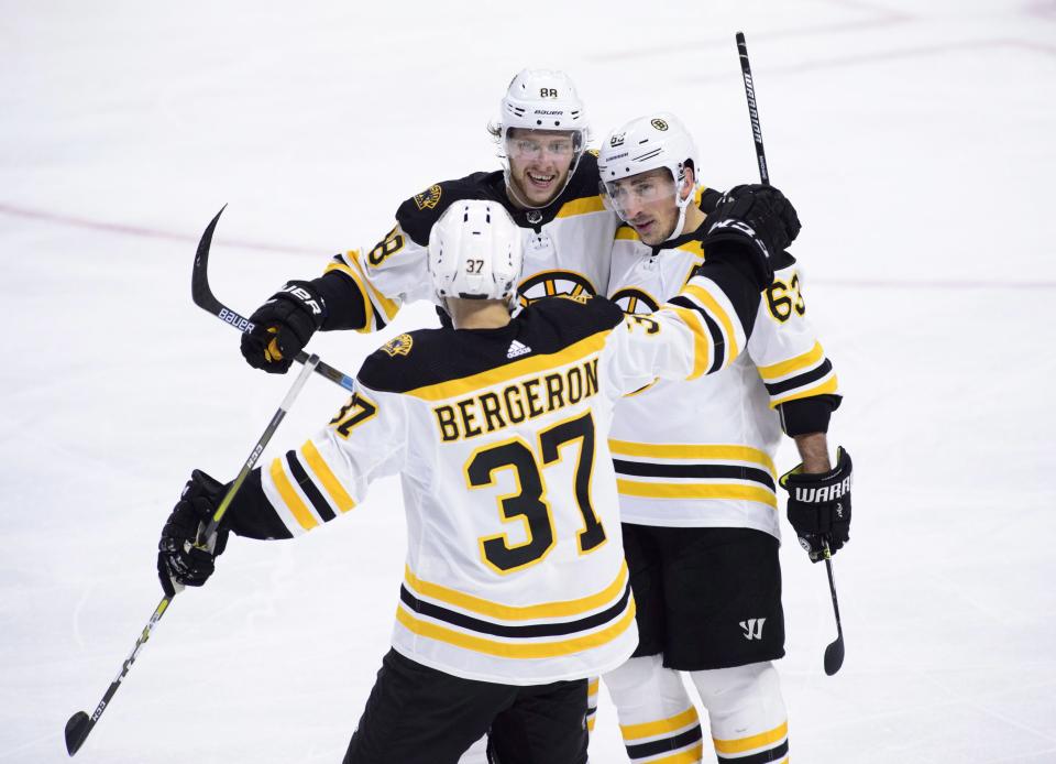 <p>
              Boston Bruins right wing David Pastrnak (88) celebrates a goal with teammates Brad Marchand (63) and Patrice Bergeron (37) while taking on the Ottawa Senators during the third period of an NHL hockey game, Tuesday, Oct. 23, 2018, in Ottawa, Ontario. (Sean Kilpatrick/The Canadian Press via AP)
            </p>