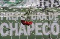 <p>Flowers hang from a soccer net at the Arena Conda stadium in Chapeco, Brazil, Tuesday, Nov. 29, 2016. A chartered plane that was carrying the Brazilian soccer team Chapecoense to the biggest match of its history crashed into a Colombian hillside and broke into pieces, Colombian officials said Tuesday. (AP Photo/Andre Penner) </p>