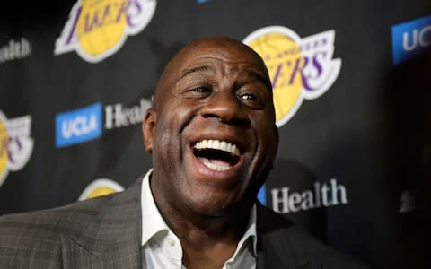 Magic Johnson speaks to reporters prior to an NBA basketball game between the Los Angeles Lakers and the Portland Trail Blazers  - Credit: AP