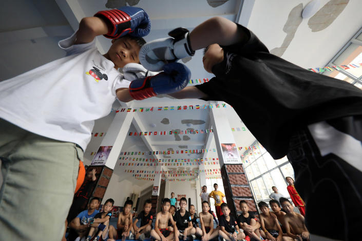 Image: Young students practice Sanda fighting skills in the gymnasium. Danzhai County, Guizhou Province, China (Costfoto / Barcroft Media via Getty Images file)