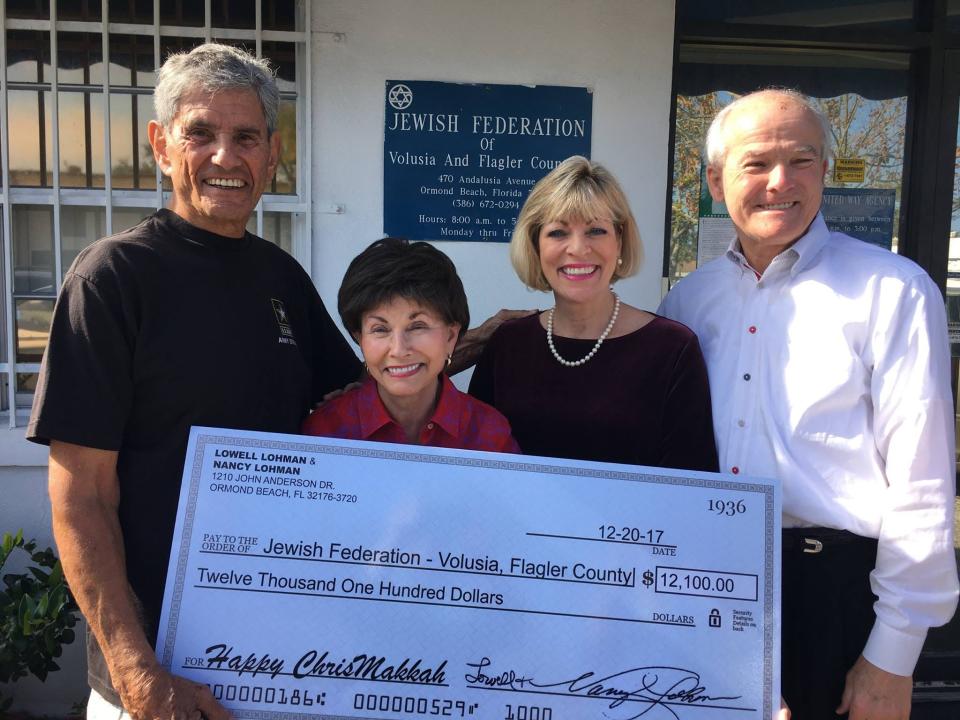 This 2017 photo features (from left) Jewish Federation of Volusia and Flagler Counties President Marvin Miller; Federation Executive Director Gloria Max, Nancy Lohman and Lowell Lohman at a check presentation to the Jewish Federation's Jerry Doliner Food Bank.