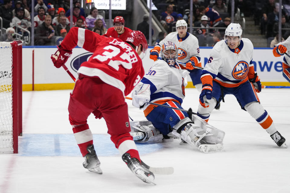 New York Islanders' Ryan Pulock (6) and goaltender Ilya Sorokin (30) watch as Detroit Red Wings' J.T. Compher (37) scores a goal during the third period of an NHL hockey game Monday, Oct. 30, 2023, in Elmont, N.Y. (AP Photo/Frank Franklin II)