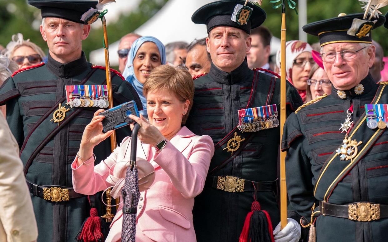 Scotland's First Minister Nicola Sturgeon takes a picture during a garden party at the Palace of Holyroodhouse in Edinburgh, Scotland, Britain, June 29, 2022. Jane Barlow/Pool via REUTERS - Jane Barlow/Pool via REUTERS