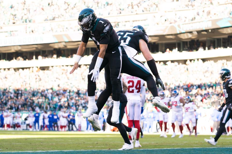 Philadelphia Eagles quarterback Jalen Hurts (1) and offensive tackle Lane Johnson (65) celebrate after a touchdown against the New York Giants during their game at Lincoln Financial Field, Saturday, Dec. 11, 2022.