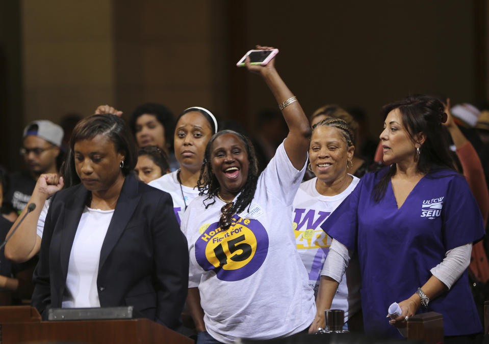 FILE - Laphonza Butler, then President of SEIU ULTCW, the United Long Term Care Workers' Union, far left, joins workers demanding the Los Angeles City Council to vote to raise the minimum wage, May 19, 2015, in Los Angeles. California Gov. Gavin Newsom has named Butler to fill the U.S. Senate seat made vacant by Sen. Dianne Feinstein's death. (AP Photo/Damian Dovarganes, File)