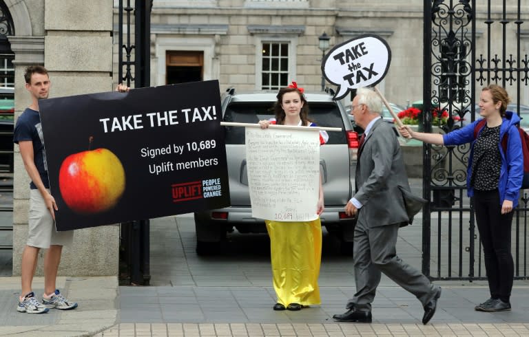 Protestors demonstrate outside Ireland's parliament buildings in support of the EU ruling to take 13 billion euros in taxes from Apple