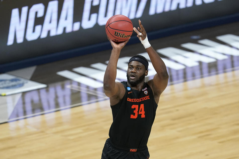 Oregon State forward Rodrigue Andela shoots during the first half of a Sweet 16 game against Loyola Chicago in the NCAA men's college basketball tournament at Bankers Life Fieldhouse, Saturday, March 27, 2021, in Indianapolis. (AP Photo/Darron Cummings)