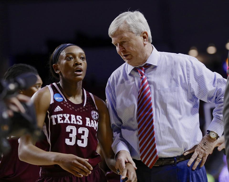 Texas A&M coach Gary Blair talks to Courtney Walker (33) at the end of the first half of a regional final game against Connecticut in the NCAA college basketball tournament in Lincoln, Neb., Monday, March 31, 2014. (AP Photo/Nati Harnik)