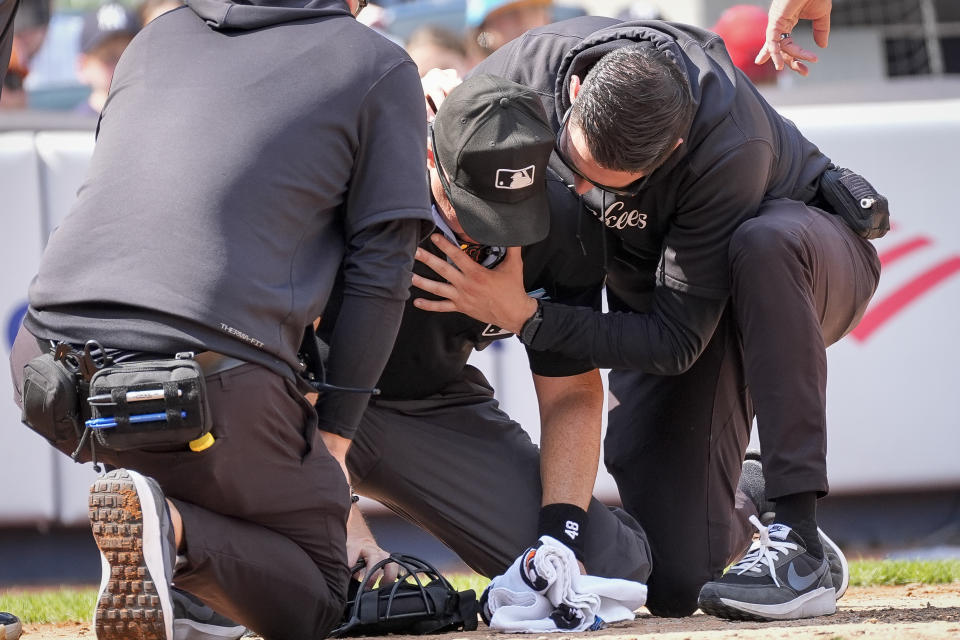 Nick Mahrley was carried off the field on a stretcher after being hit in the head with the barrel of Giancarlo Stanton's bat. (AP Photo/Bryan Woolston)