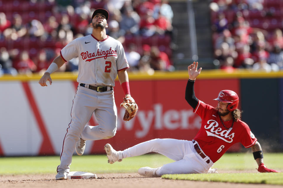 Cincinnati Reds' Jonathan India, right, slides safely into second base as Washington Nationals' Luis Garcia looks for a loose ball during the seventh inning of a baseball game Sunday, Sept. 26, 2021, in Cincinnati. The Reds beat Nationals 9-2. (AP Photo/Jay LaPrete)