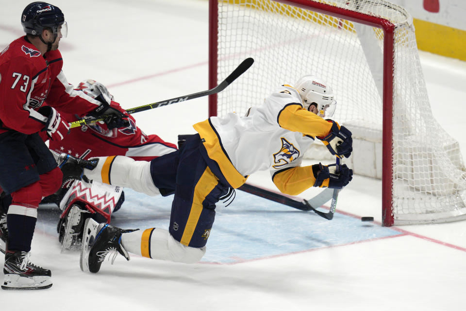 Nashville Predators defenseman Ryan McDonagh, right, scores against the Washington Capitals during the third period of an NHL hockey game Friday, Jan. 6, 2023, in Washington. The Predators won 3-2. (AP Photo/Jess Rapfogel)