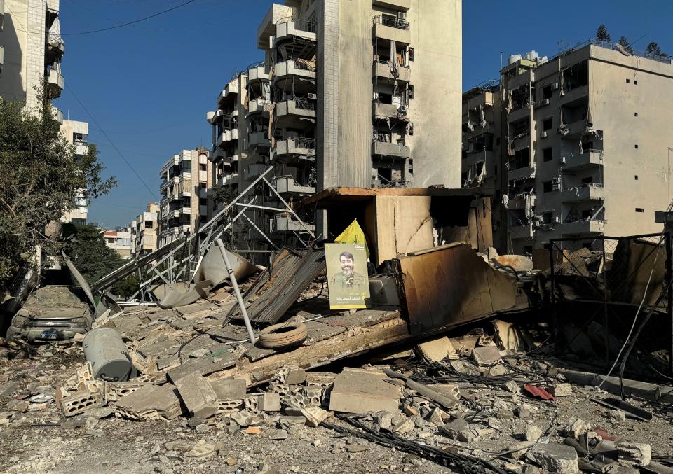 A Hezbollah ‘martyr’ poster sits among the rubble of a southern Beirut suburb following an overnight Israeli airstrike (REUTERS)