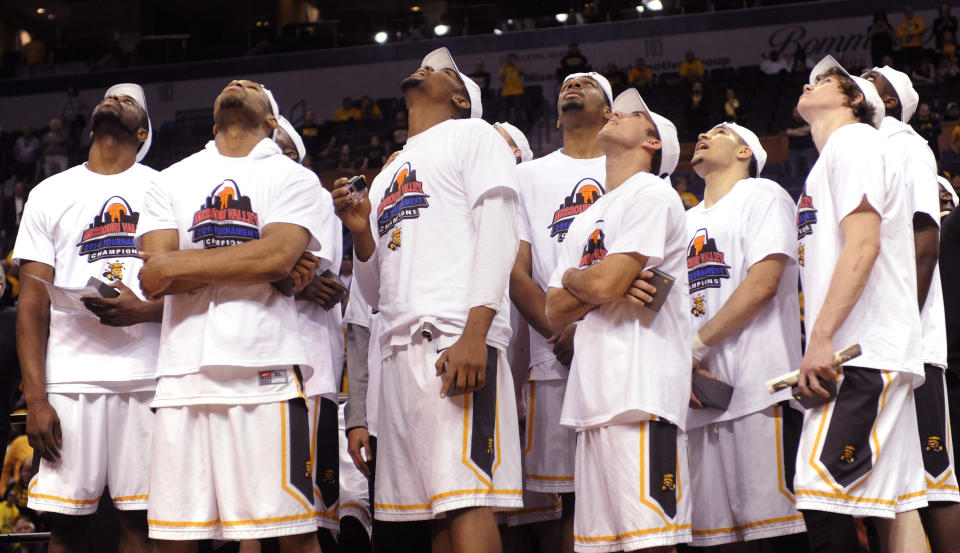 Wichita State players watch highlights of their victory over Indiana State on the overhead monitor in an NCAA college basketball game in the championship of the Missouri Valley Conference men's tournament, Sunday, March 9, 2014, in St. Louis. (AP Photo/Bill Boyce)