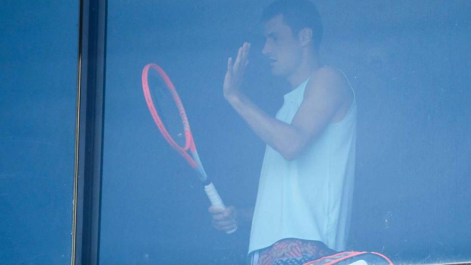 Bernard Tomic, pictured here exercising in his hotel room in Melbourne.