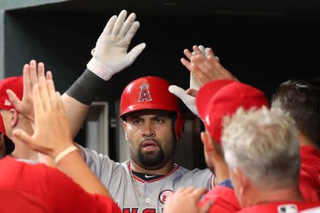 Aug 18, 2017; Baltimore, MD, USA; Los Angeles Angels designated hitter Albert Pujols (5) greeted by teammates after connecting on a two run home run against the Baltimore Orioles at Oriole Park at Camden Yards. Mitch Stringer-USA TODAY Sports